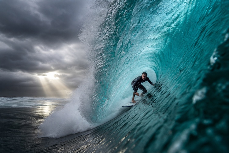 surfer riding storm wave